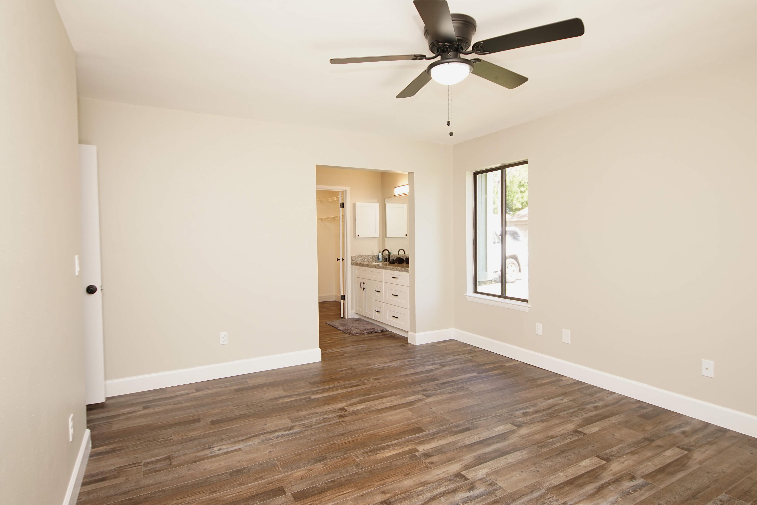 800 Bay Drive, Unit 8 Niceville, FL 32578 - Photo 10 of 29 a view of an empty room with a window and wooden floor