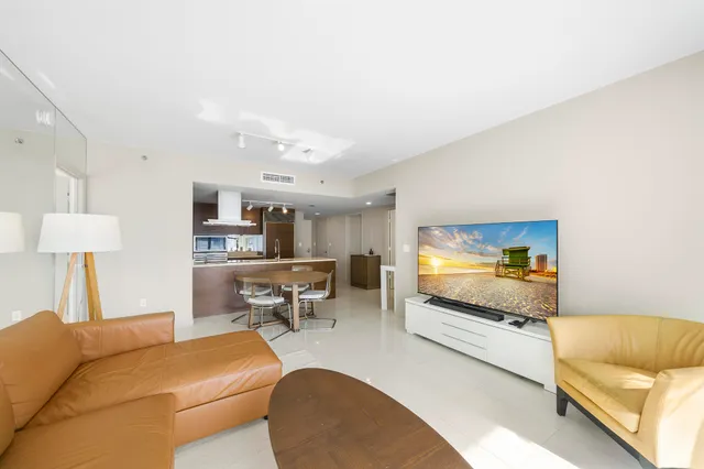 a bedroom with a large bed and a large window