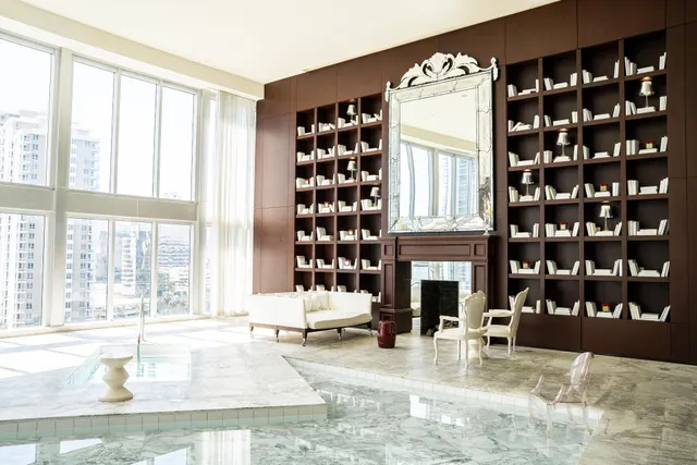 a living room with fireplace furniture and a large window