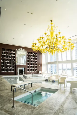 a living room with furniture a dining table and a large window