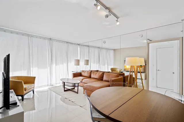 a kitchen with stainless steel appliances granite countertop a sink and a refrigerator