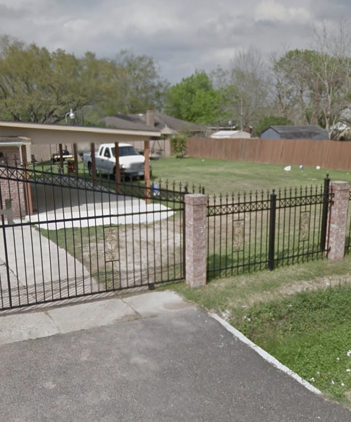 a view of a fence and trees in the background