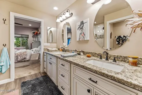 a spacious bathroom with a granite countertop sink and a mirror