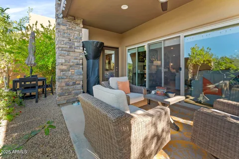 a view of a patio with couches table and chairs and potted plants