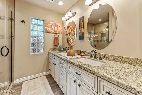 a spacious bathroom with a granite countertop sink mirror and double