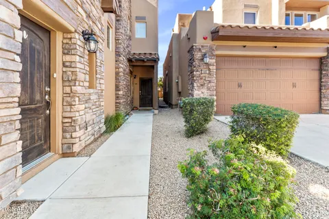 a front view of a building with a bunch of flower plants