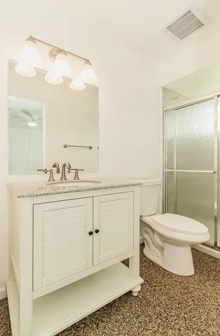 a bathroom with a toilet a sink and a mirror