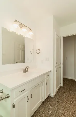 a spacious bathroom with a double vanity sink mirror and