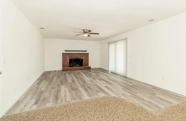 a view of empty room with a fireplace