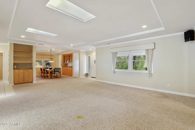 an empty room with furniture and a window