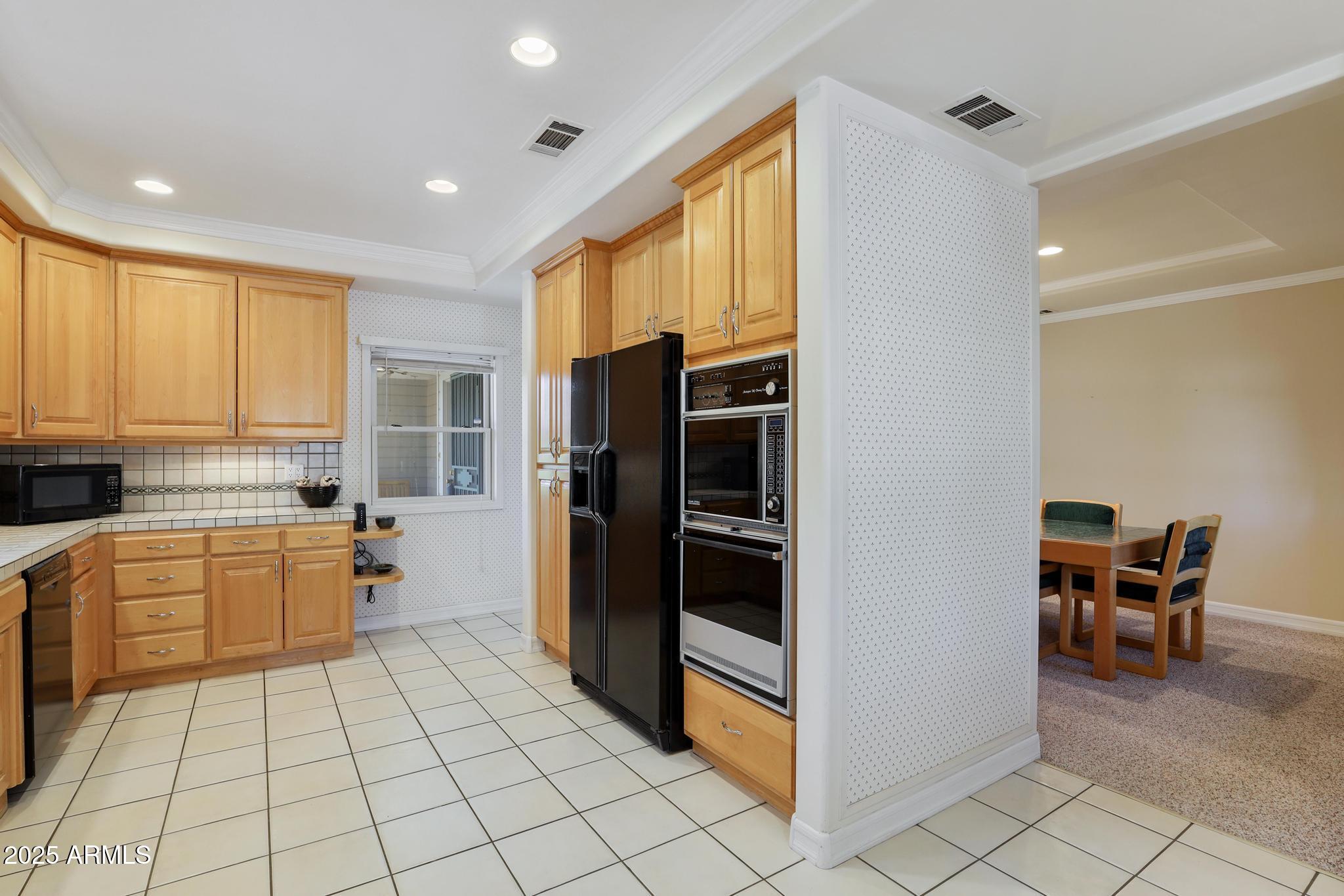 503 West Locust Road Payson, AZ 85541 - Photo 13 of 40 a kitchen with a refrigerator and wooden cabinets