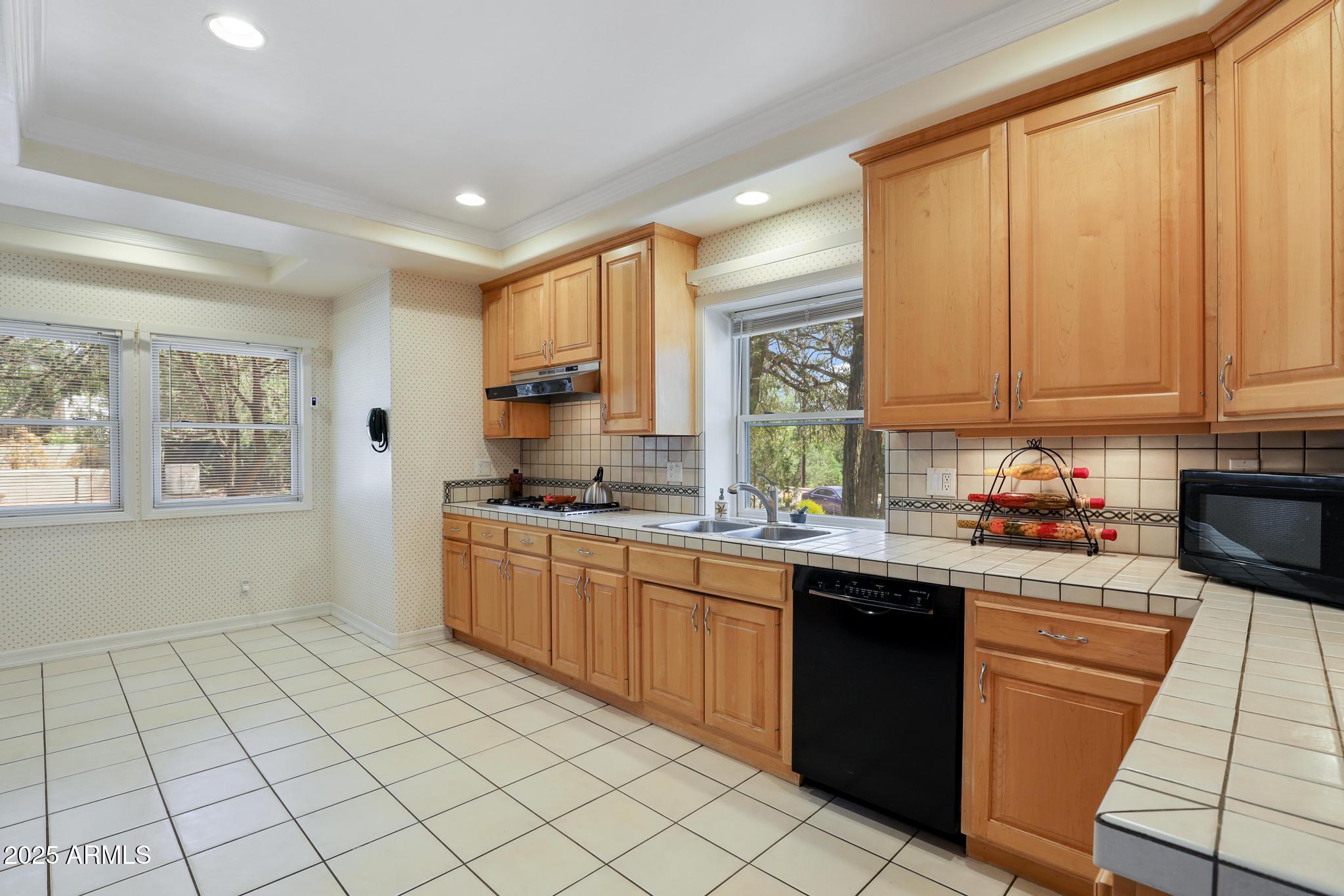 503 West Locust Road Payson, AZ 85541 - Photo 14 of 40 a kitchen with a sink window and cabinets