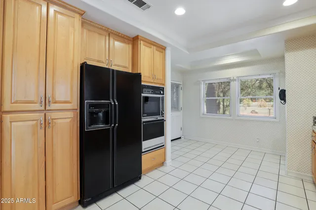 a kitchen with stainless steel appliances a refrigerator and a stove top oven