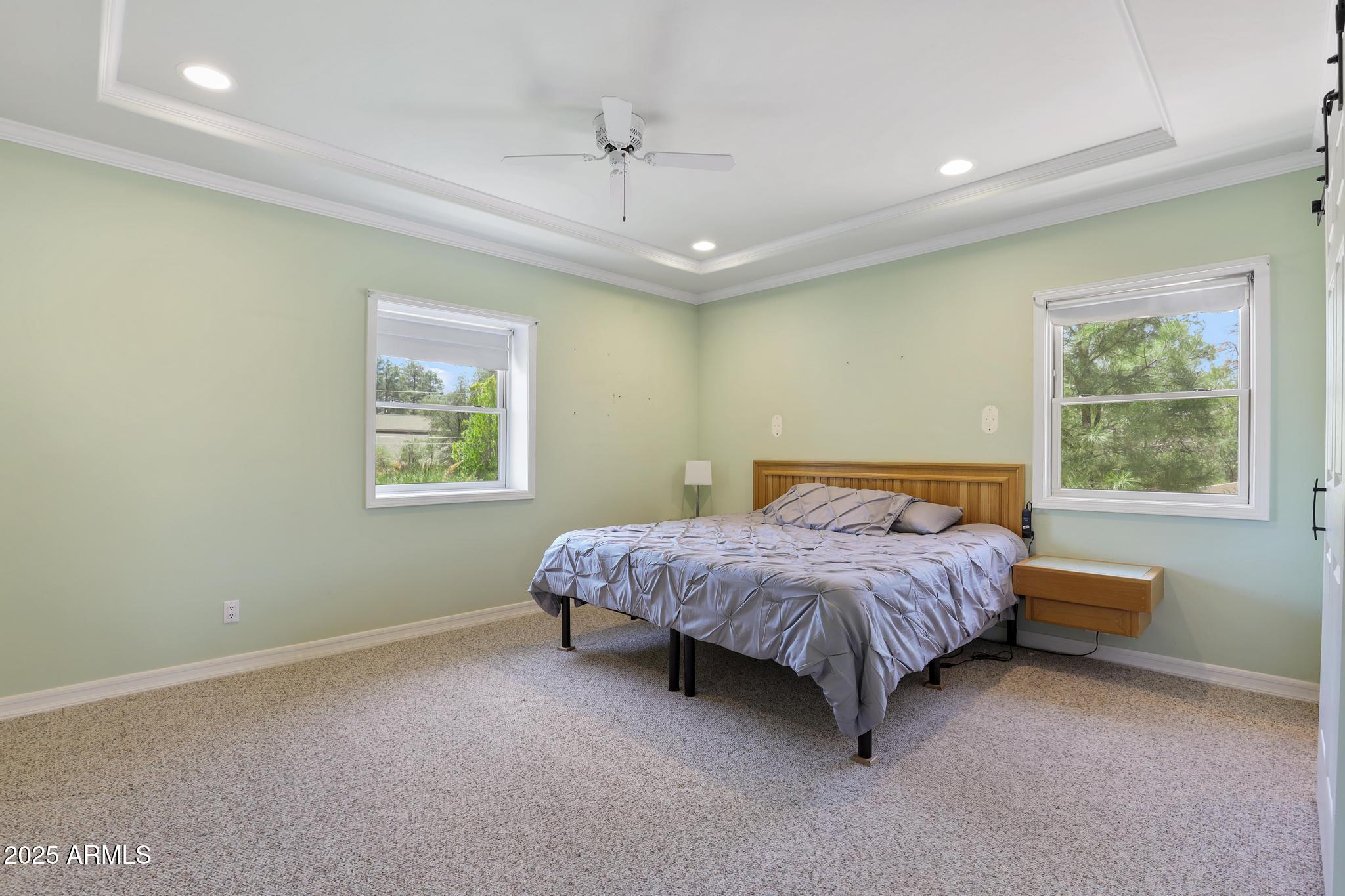 503 West Locust Road Payson, AZ 85541 - Photo 17 of 40 a spacious bedroom with a bed mirror and window