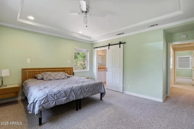 a bedroom with a bed closet and a mirror