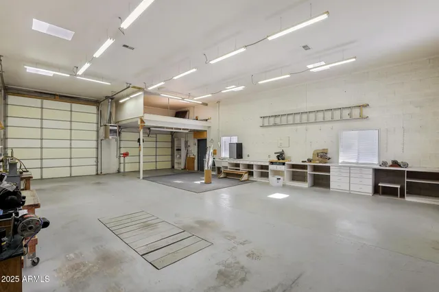 a view of a livingroom with gym equipment and a large window