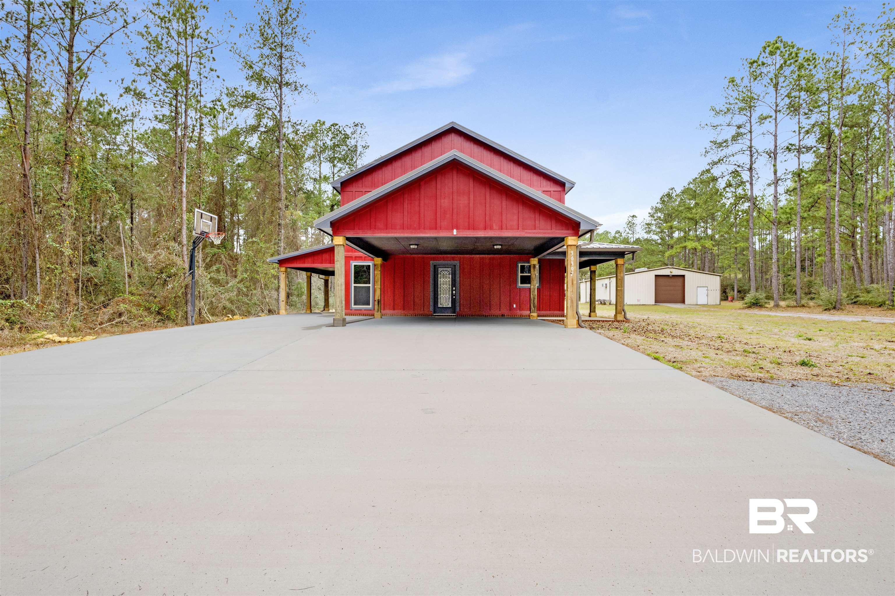 36397 Alexandria Trail Stapleton, AL 36578 - Photo 16 of 65 View of front of home featuring an outdoor structure, covered porch, and concrete driveway