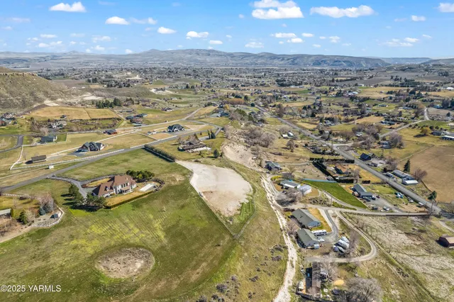 an aerial view of a residential houses with outdoor space