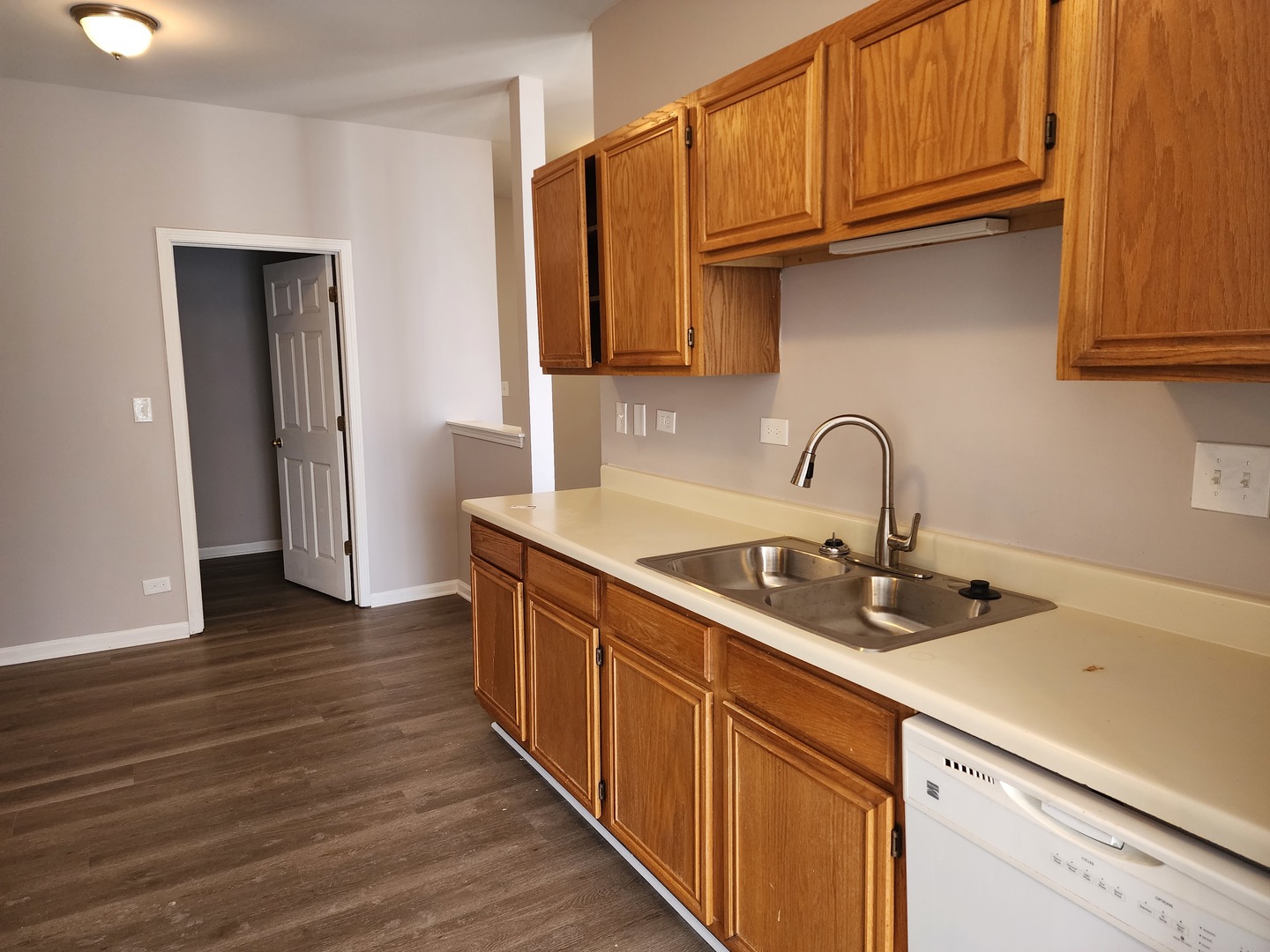 13 Brian Court Algonquin, IL 60102 - Photo 6 of 13 a kitchen with stainless steel appliances granite countertop a sink dishwasher stove and cabinets with wooden floor