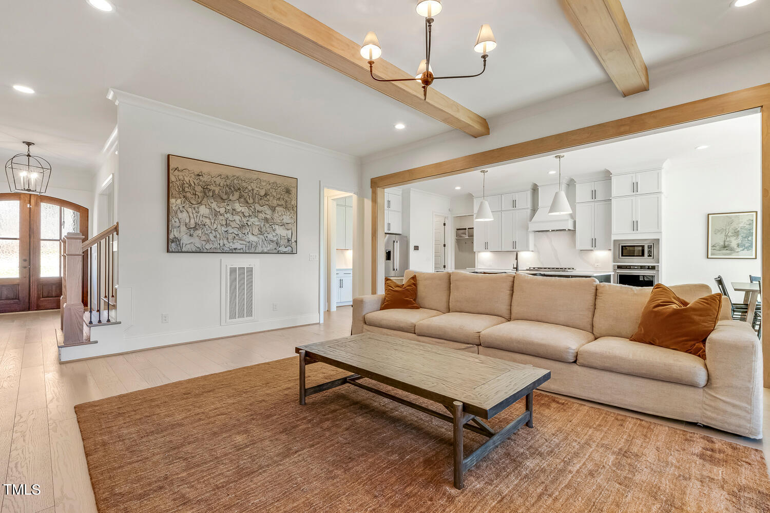 900 Harrison Ridge Road Wake Forest, NC 27587 - Photo 18 of 78 a living room with furniture a chandelier and a flat screen tv
