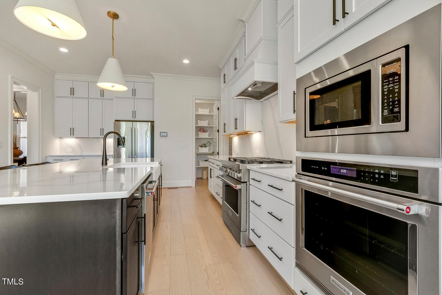 900 Harrison Ridge Road Wake Forest, NC 27587 - Photo 25 of 78 a kitchen with stainless steel appliances a stove sink microwave and cabinets