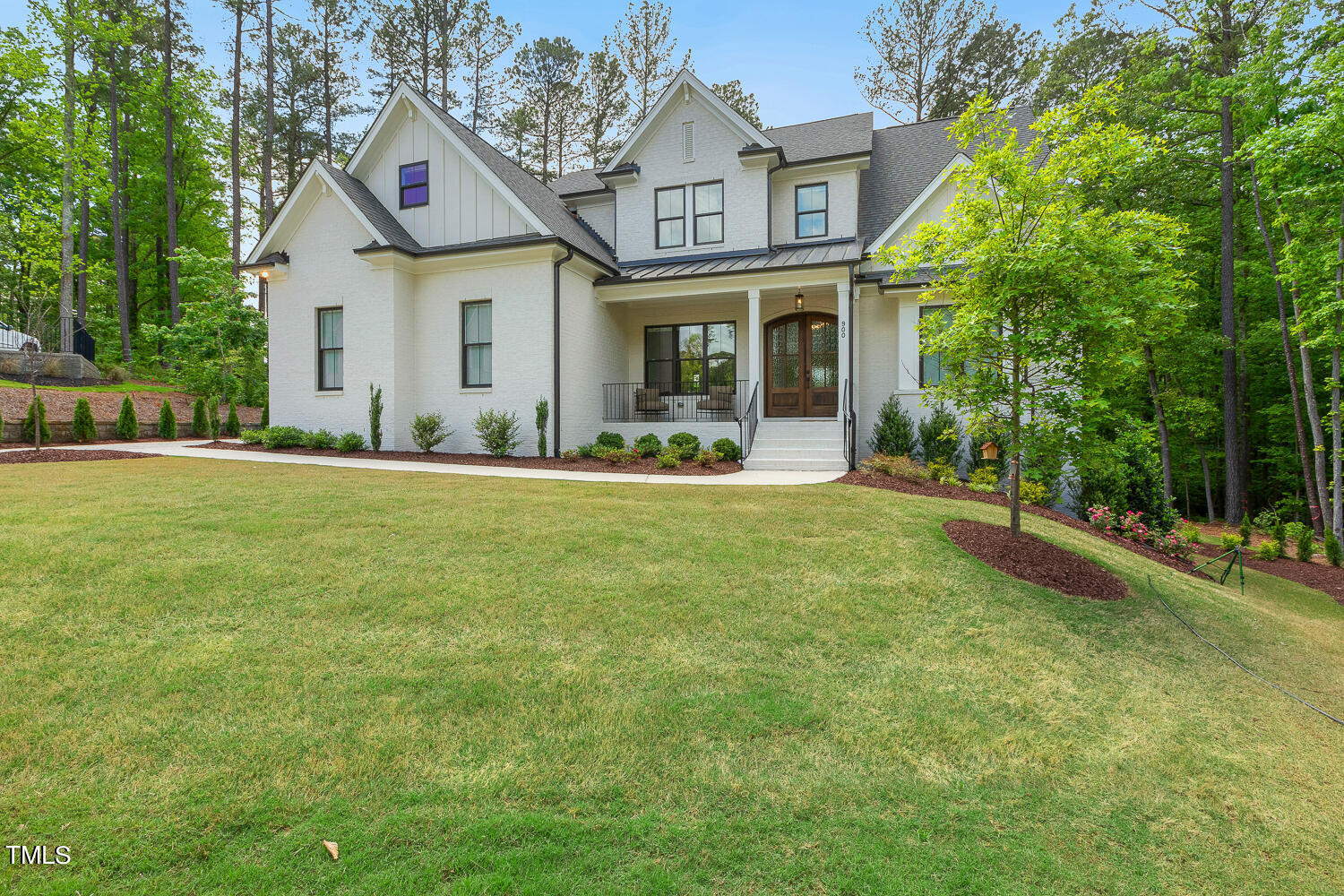 900 Harrison Ridge Road Wake Forest, NC 27587 - Photo 4 of 78 a front view of a house with a yard table and chairs