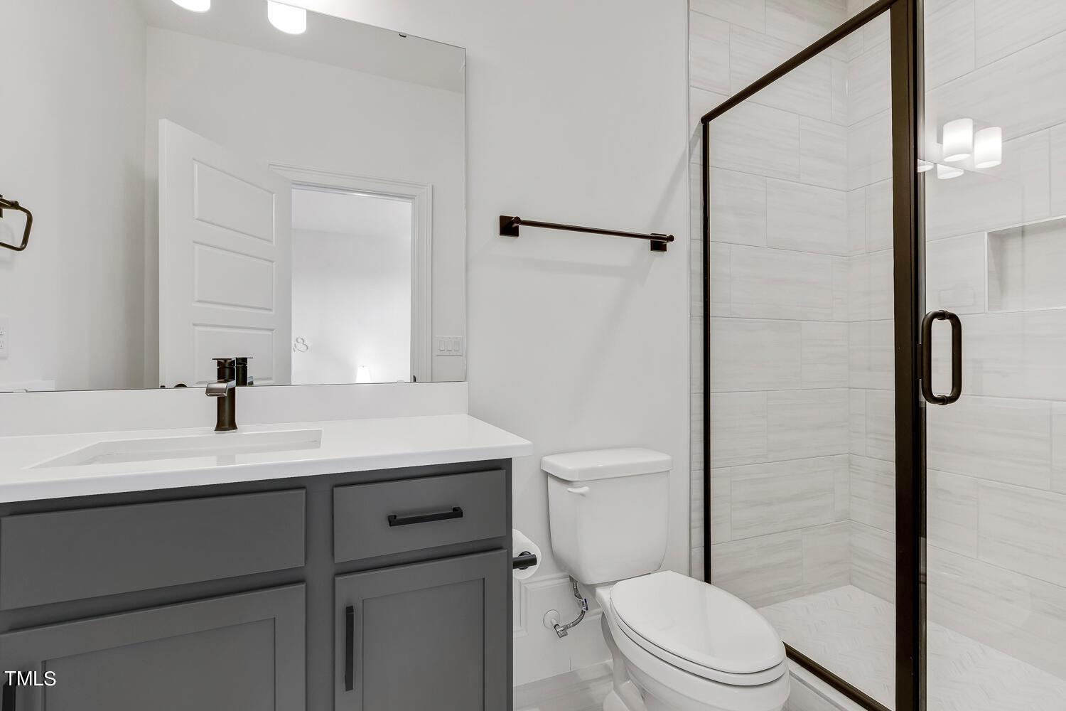900 Harrison Ridge Road Wake Forest, NC 27587 - Photo 52 of 78 a bathroom with a sink a toilet a shower and a mirror