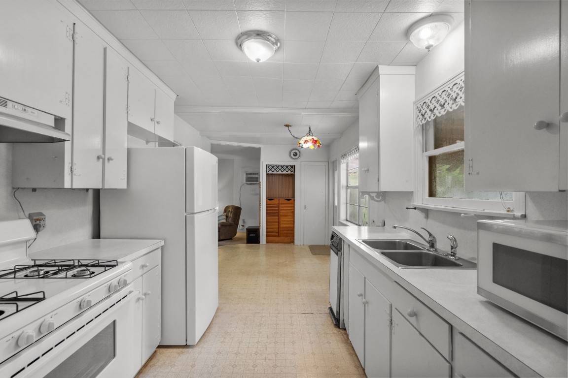 1126 Orange Street La Marque, TX 77568 - Photo 11 of 36 a kitchen with a sink stove and refrigerator