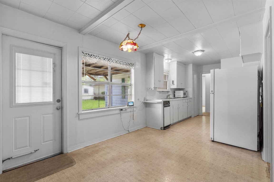 1126 Orange Street La Marque, TX 77568 - Photo 13 of 36 a view of a kitchen with a sink cabinet and a refrigerator