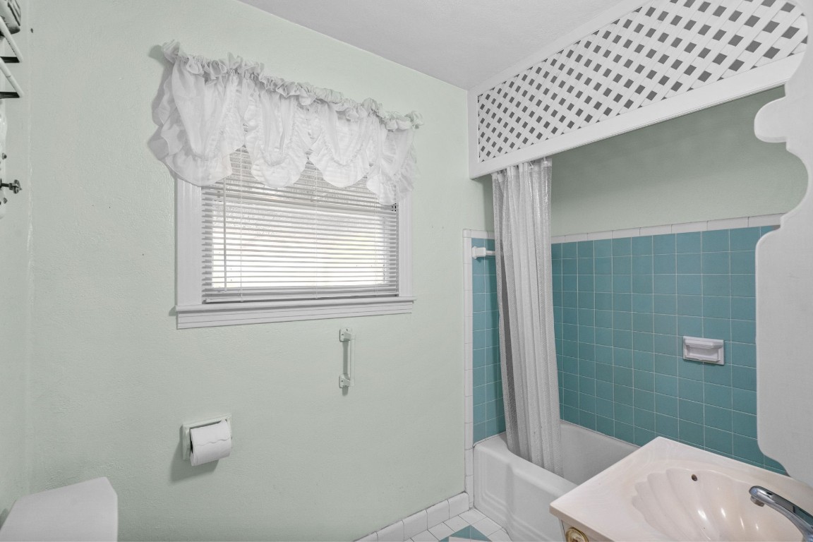 1126 Orange Street La Marque, TX 77568 - Photo 22 of 36 a bathroom with a sink a toilet and shower