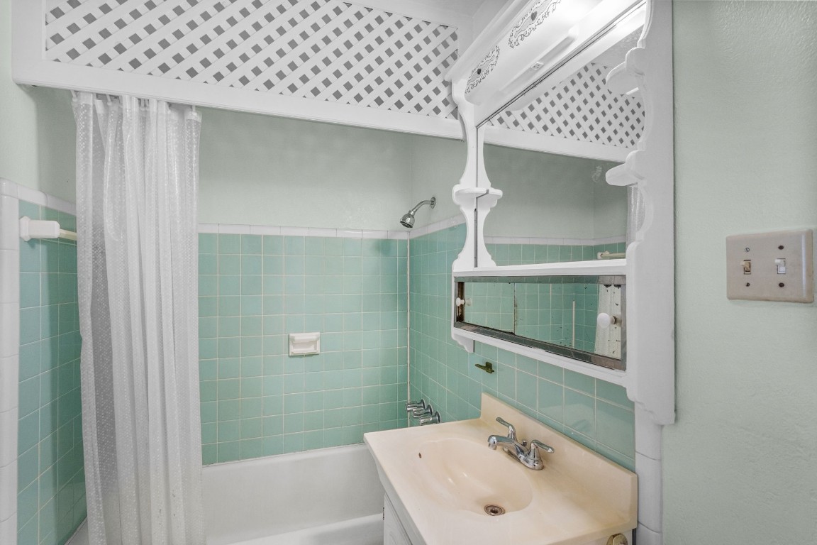 1126 Orange Street La Marque, TX 77568 - Photo 23 of 36 a bathroom with a sink a glass door and shower