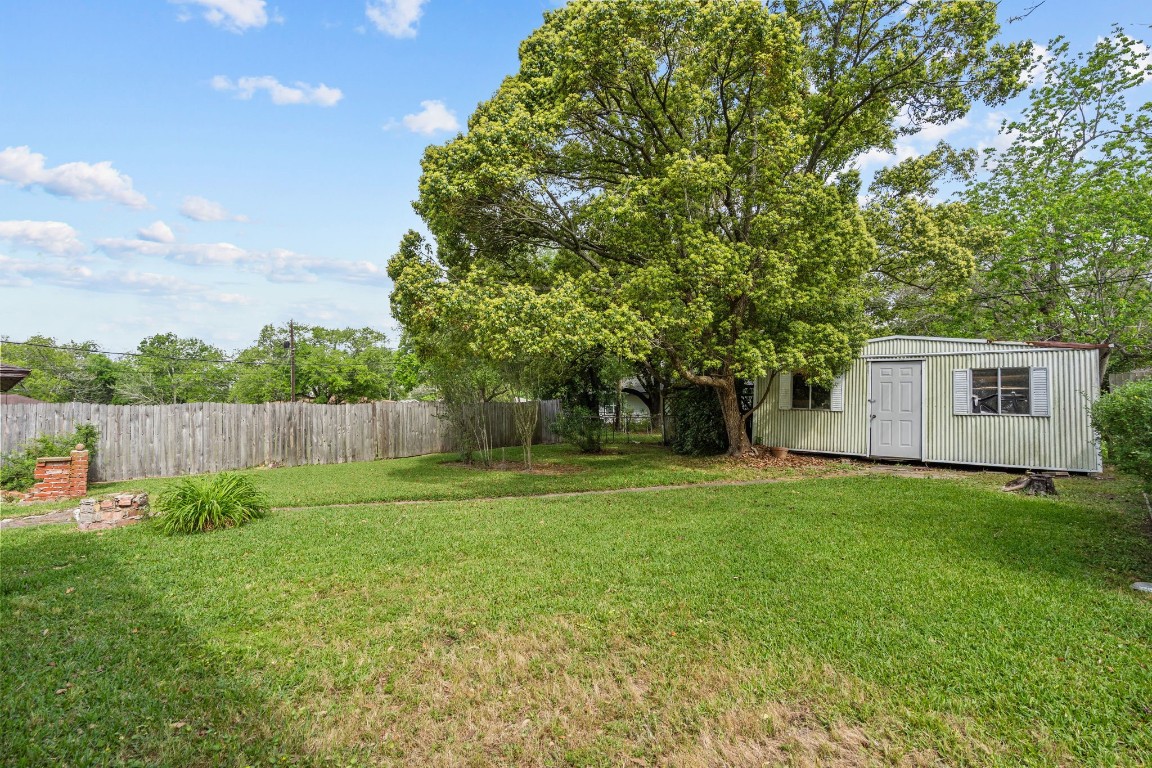 1126 Orange Street La Marque, TX 77568 - Photo 35 of 36 a view of a backyard with a garden and trees