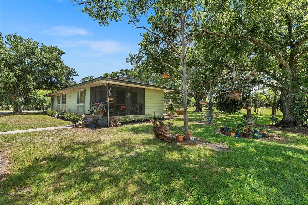 10100 West Midway Road Fort Pierce, FL 34945 - Photo 5 of 15 a view of a house with a yard