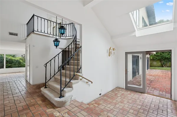 a view of staircase with white walls and windows
