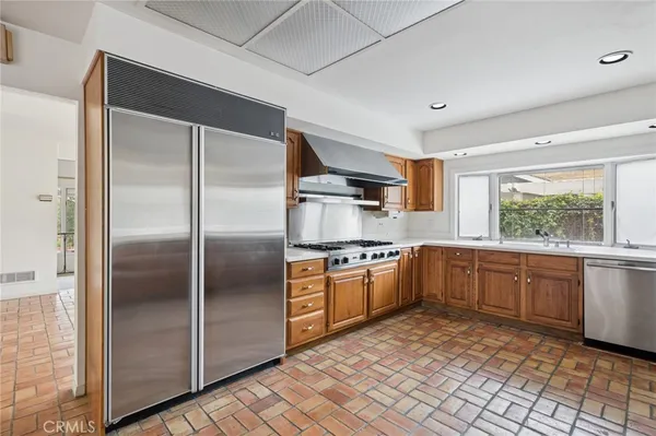 a kitchen with stainless steel appliances granite countertop a refrigerator and sink