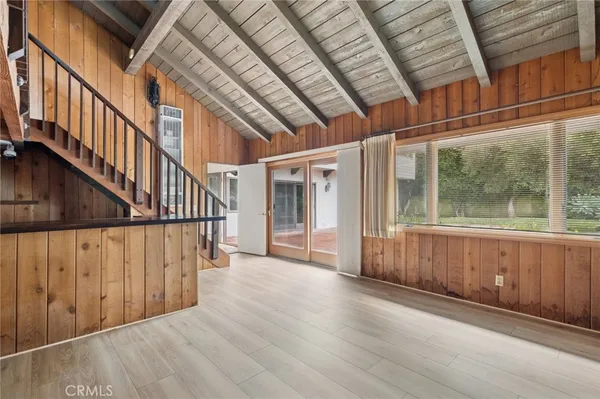 a view of an entryway with wooden floor