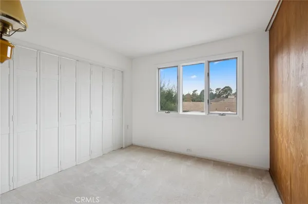 a spacious bathroom with a granite countertop double vanity sink a mirror and a shower