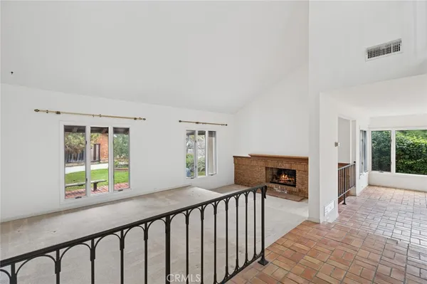 a view of a porch with wooden floor and iron fence