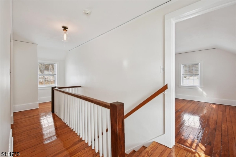 247 Liberty Corner Road Far Hills, NJ 07931 - Photo 9 of 18 a view of a hallway with wooden floor and staircase