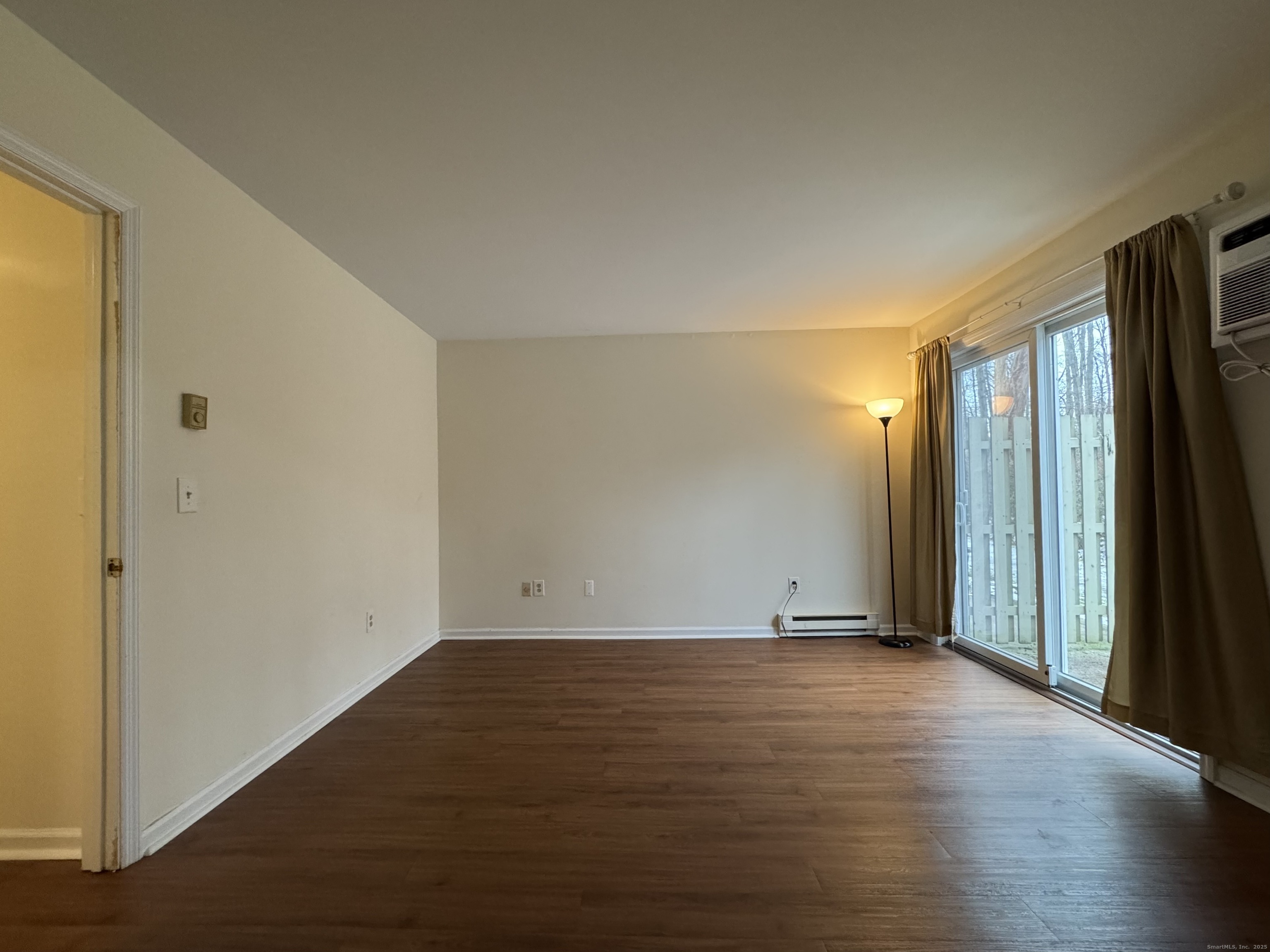 136 Pembroke Road, Unit 11101 Danbury, CT 06811 - Photo 14 of 17 a view of an empty room with wooden floor and a window