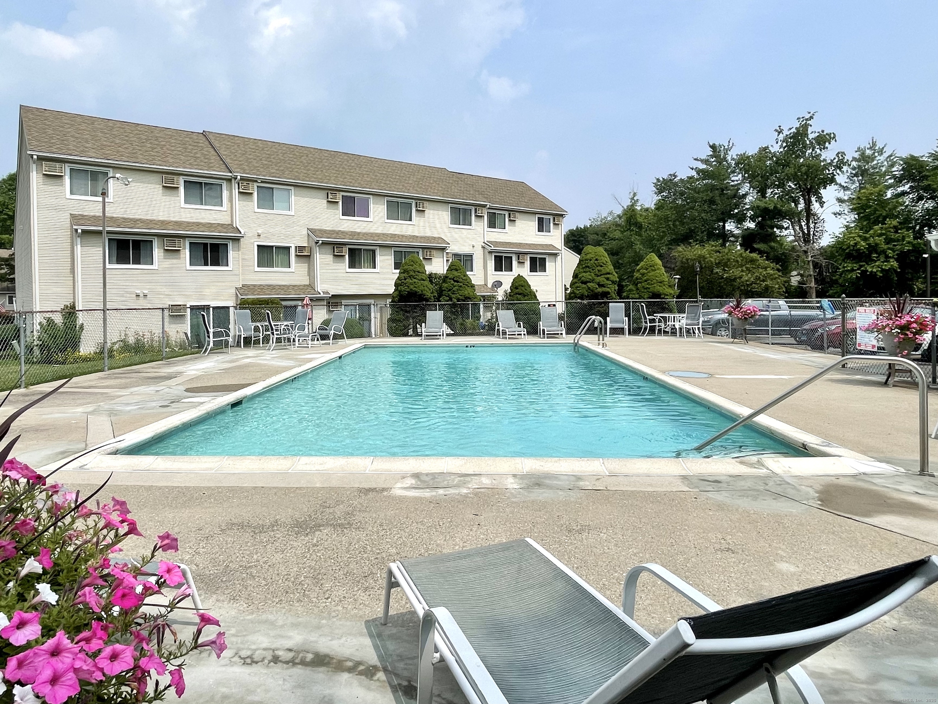 136 Pembroke Road, Unit 11101 Danbury, CT 06811 - Photo 16 of 17 a view of swimming pool with outdoor seating and a pathway