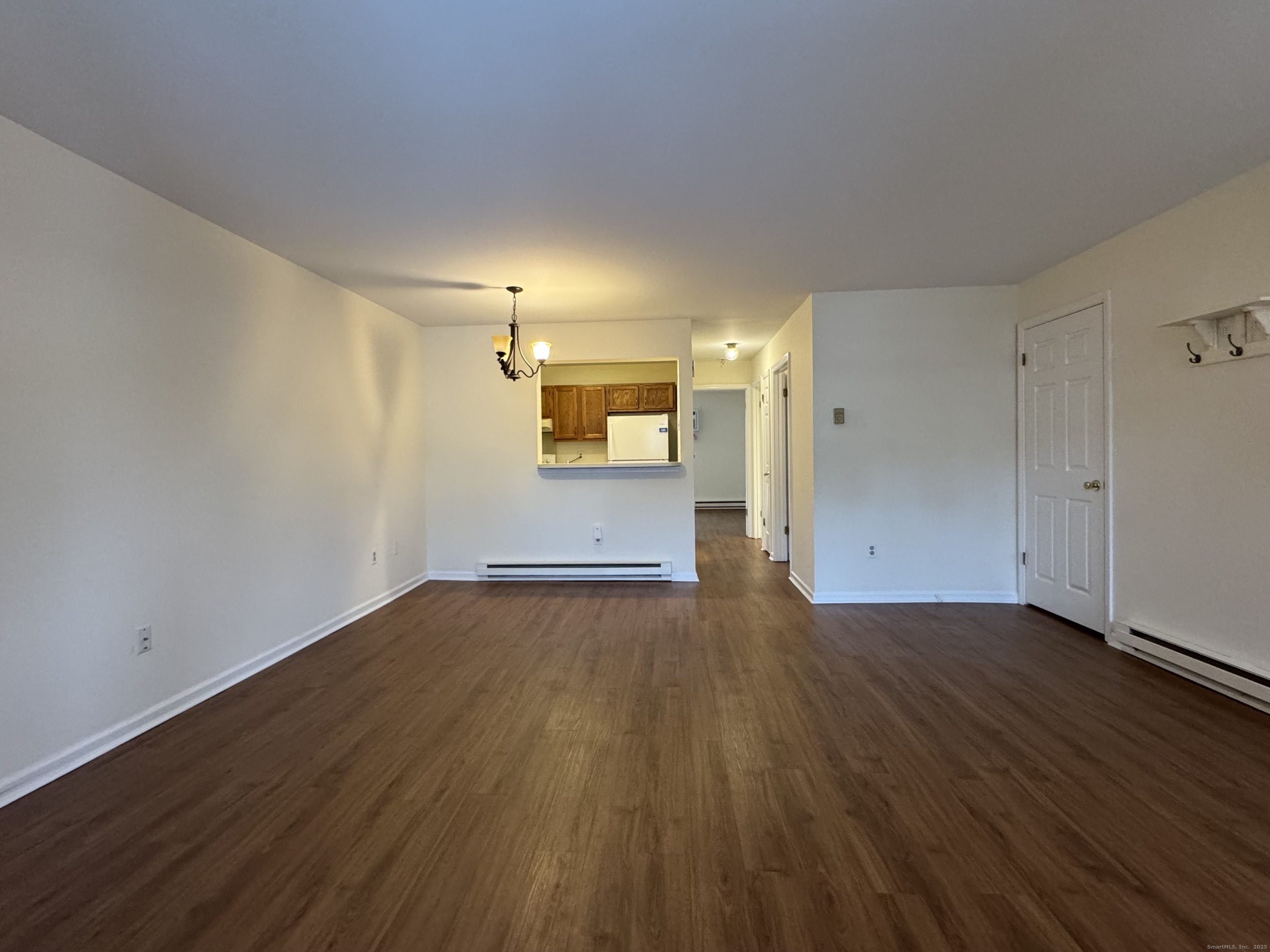 136 Pembroke Road, Unit 11101 Danbury, CT 06811 - Photo 5 of 17 an empty room with wooden floor and windows