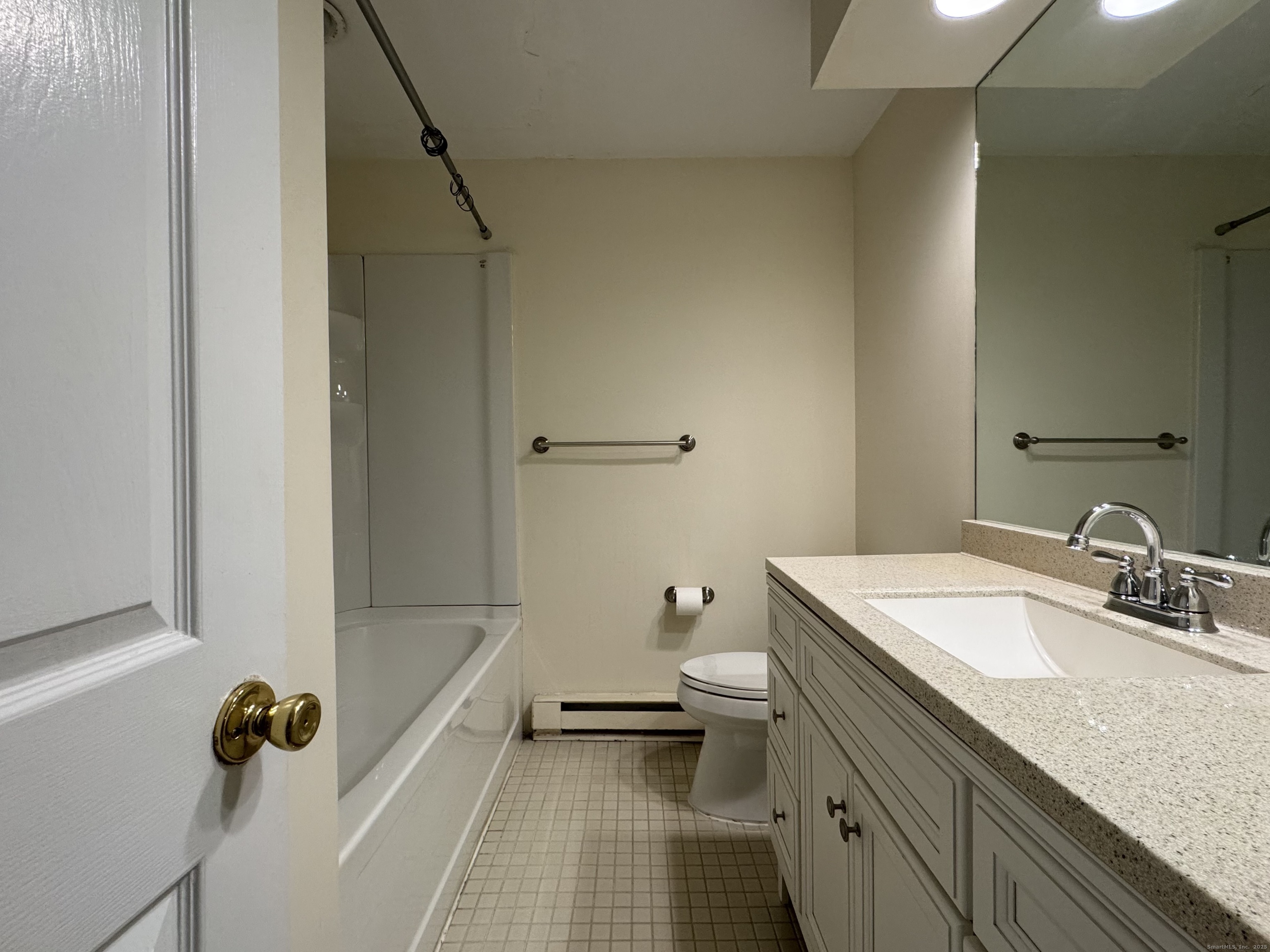 136 Pembroke Road, Unit 11101 Danbury, CT 06811 - Photo 10 of 17 a bathroom with a granite countertop sink a toilet and shower