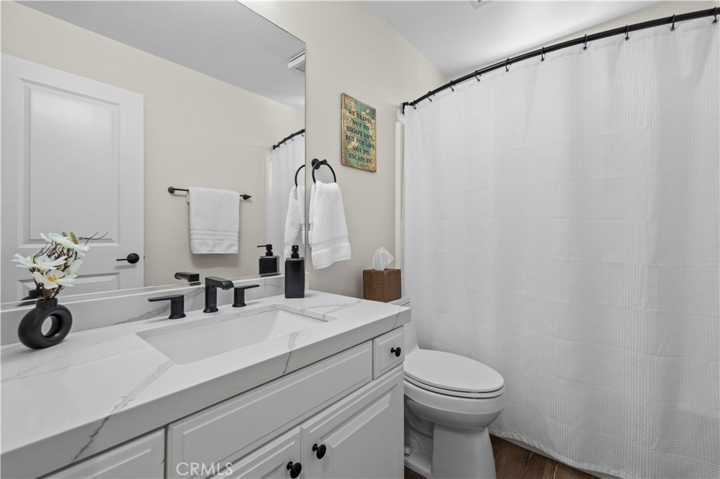 28454 Santa Rosa Lane Saugus, CA 91350 - Photo 19 of 36 a bathroom with a sink a toilet and shower curtain