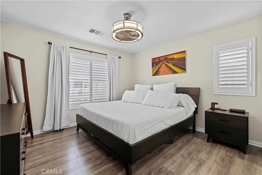 28454 Santa Rosa Lane Saugus, CA 91350 - Photo 20 of 36 a spacious bedroom with a bed and a chandelier