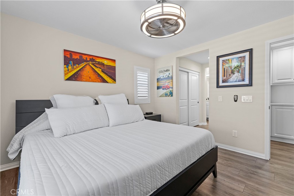 28454 Santa Rosa Lane Saugus, CA 91350 - Photo 21 of 36 a bedroom with a bed and a chandelier