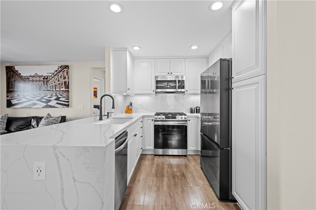 28454 Santa Rosa Lane Saugus, CA 91350 - Photo 7 of 36 a kitchen with stainless steel appliances a sink stove and refrigerator