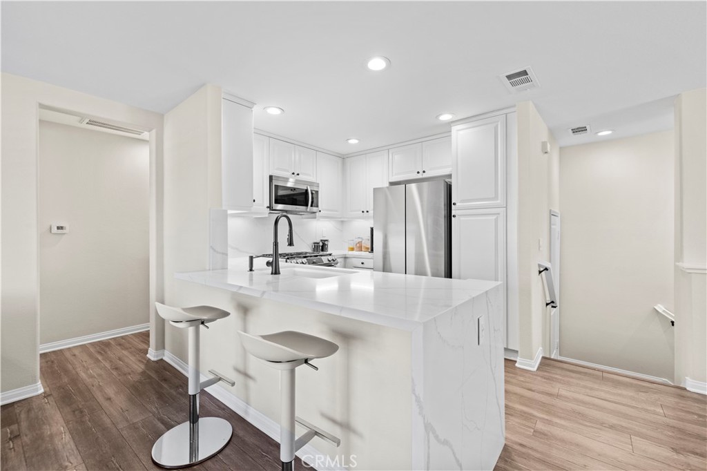 28454 Santa Rosa Lane Saugus, CA 91350 - Photo 8 of 36 a kitchen with refrigerator and chairs