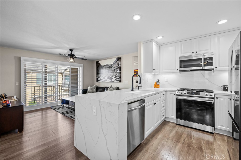 28454 Santa Rosa Lane Saugus, CA 91350 - Photo 9 of 36 a kitchen with kitchen island a stove a sink and a refrigerator