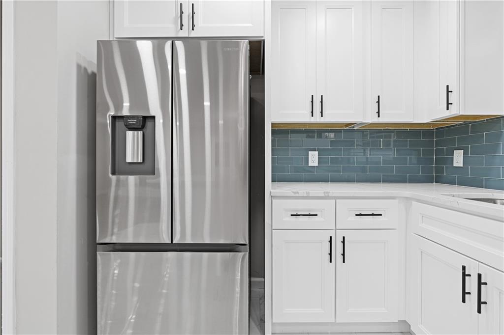 353 Old Rosser Road Stone Mountain, GA 30087 - Photo 11 of 46 a kitchen with stainless steel appliances granite countertop a refrigerator and a sink